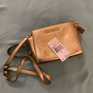 Michael Kors Selma mini messenger leather crossbody in metallic/shiny gold